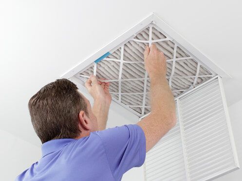 HVAC Technician Checking Air Filter in Raleigh, NC