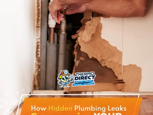 A person repairs exposed plumbing behind a damaged wall with peeling material, highlighting issues with hidden plumbing leaks and potential home foundation risks.