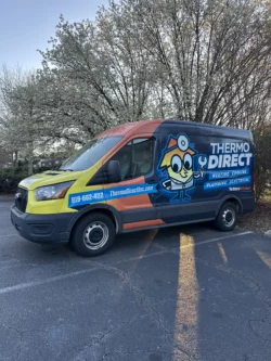A Thermo Direct service van is parked outside, displaying company branding, contact information, and a cartoon technician graphic on its side.
